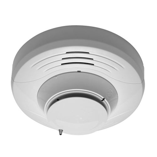 Silent Knight SK-FIRE-CO-W fire and carbon monoxide detector mounted on a wall, compact safety device for home security
